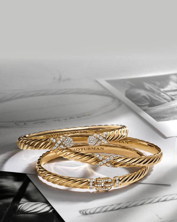 Three David Yurman Sculpted Cable bracelets.