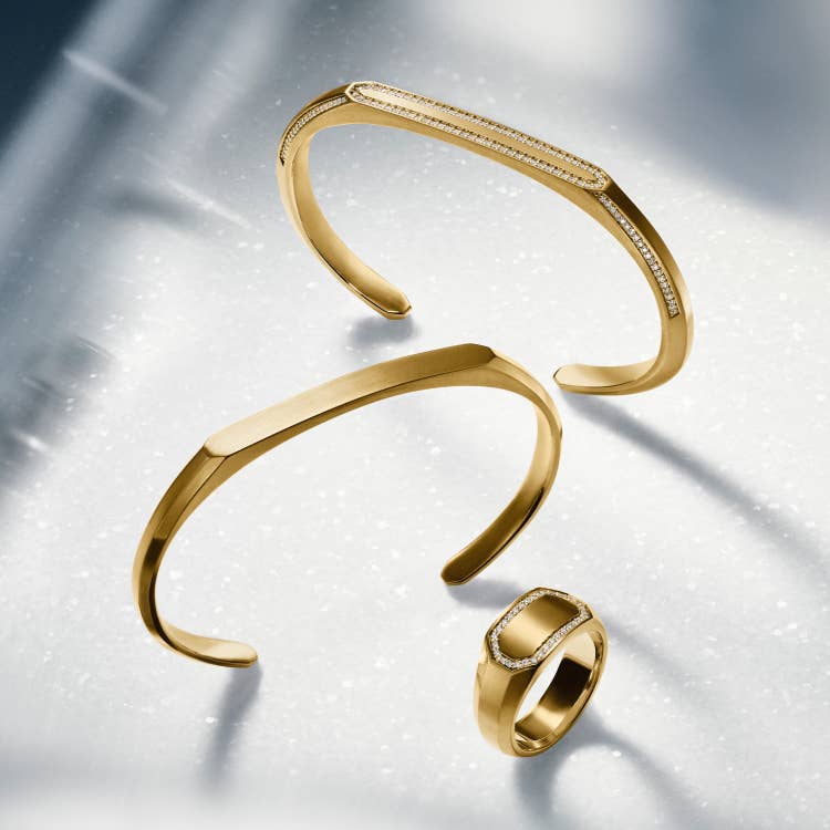 An image of David Yurman bracelets and rings in gold.