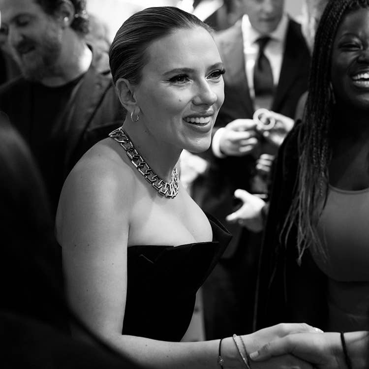 An image of Scarlett Johansson shaking hands with guests