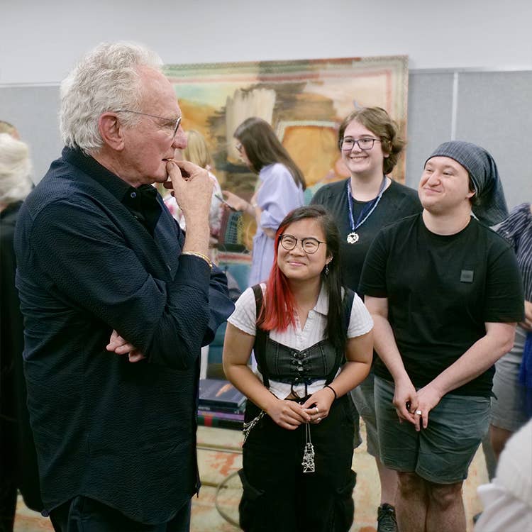 An image of David Yurman speaking to students from SCAD.