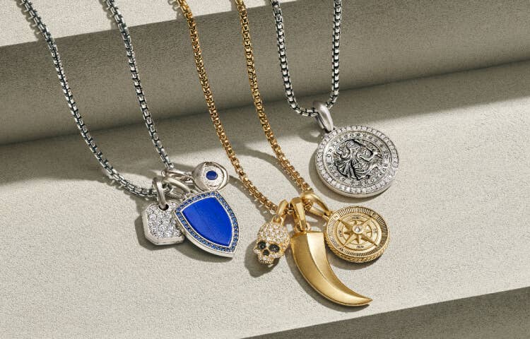 An image of 7 amulets on silver and gold box chains.