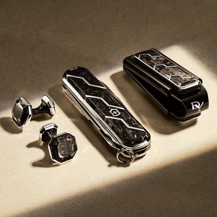 An image of mens cufflinks, a pocketknife and money clip.