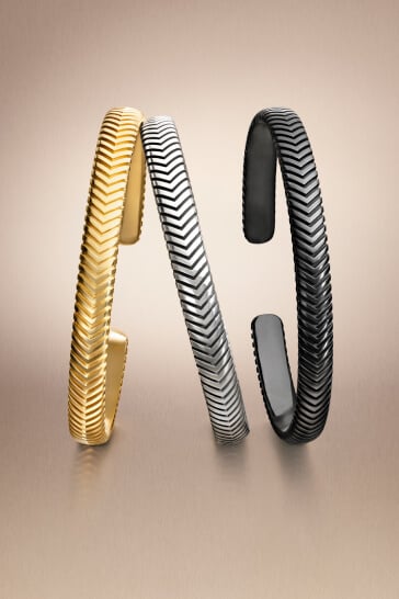 Three David Yurman cuff bracelets for men.