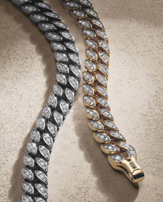 A silver and gold chain with pavé diamonds from the David Yurman Curb Chain collection.