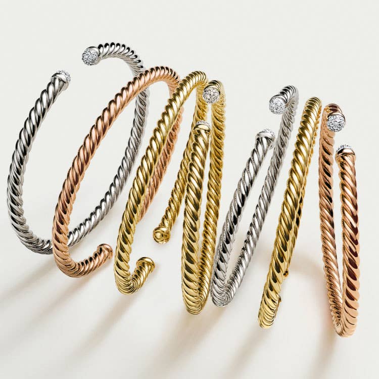 An image of 7 CableSpira bracelets in yellow, white and rose gold.