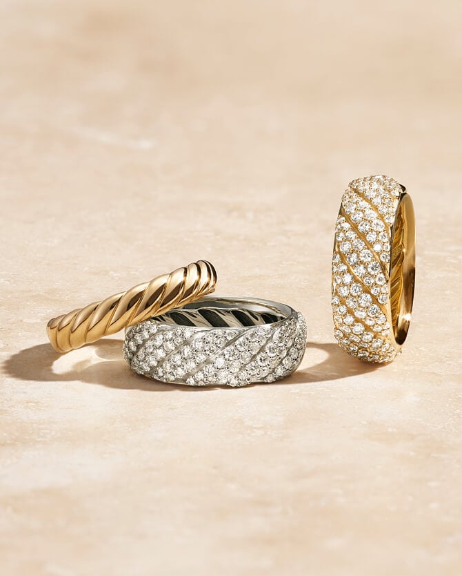 Three David Yurman rings in various metals.