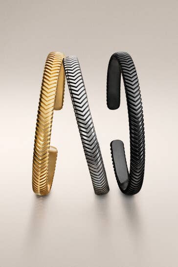 Three David Yurman men's bracelets.