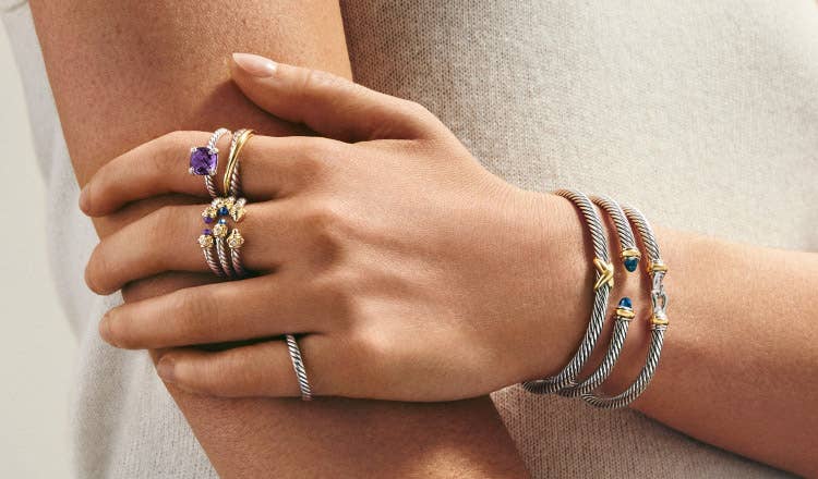 An image of a model wearing petite rings and bracelets.