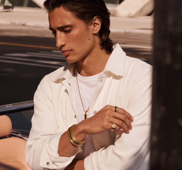 An image of James Turlington wearing David Yurman Pyramid..