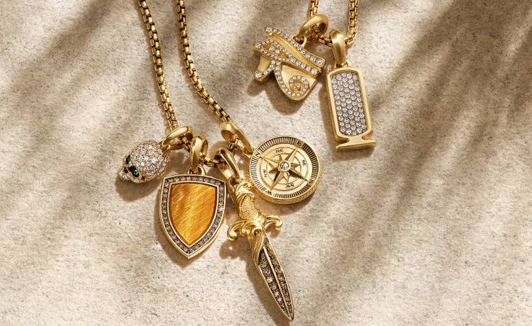 An image of six amulets in yellow gold.