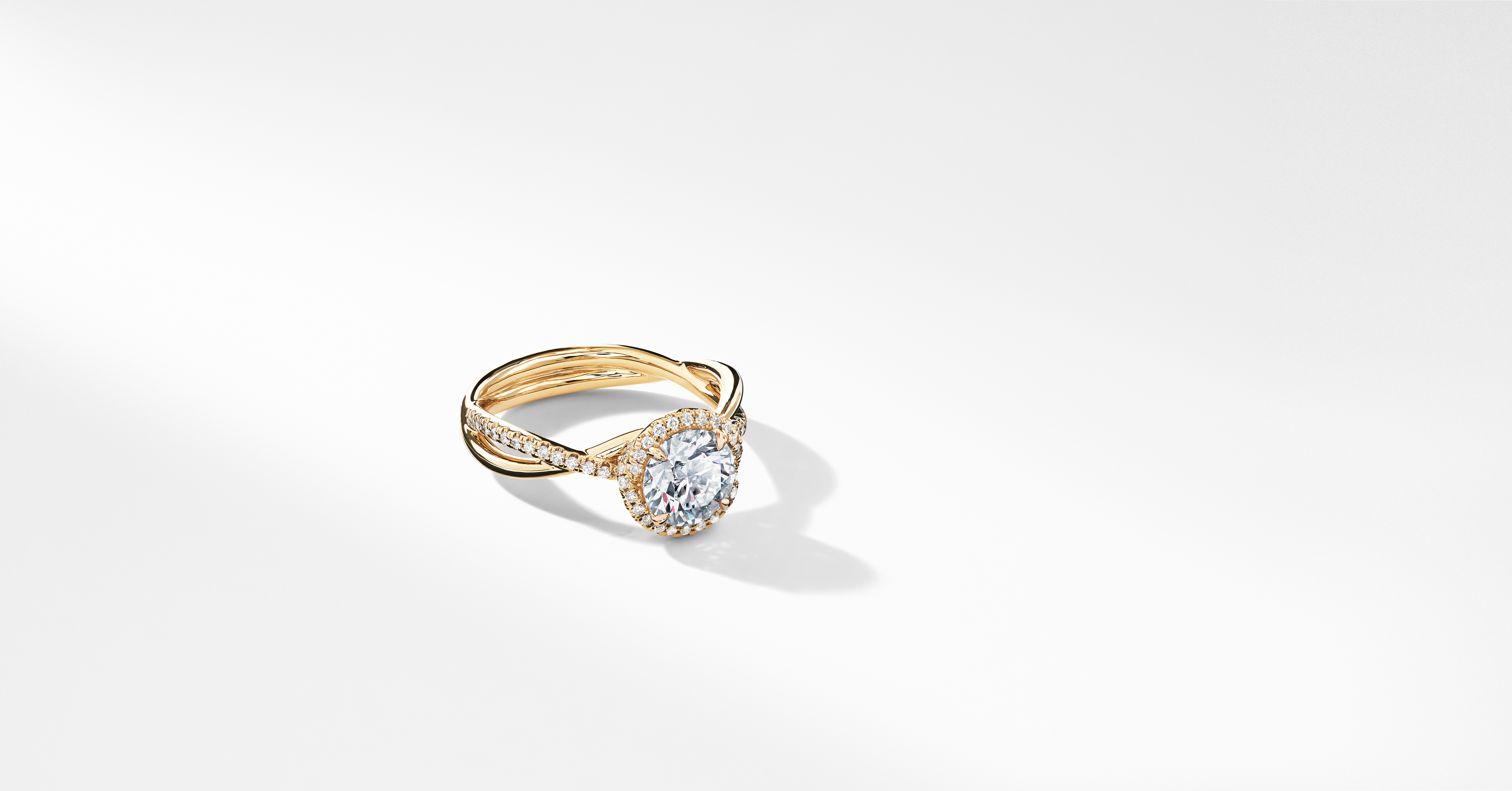 DY Infinity Half Pavé Halo Engagement Ring in 18K Yellow Gold, Round